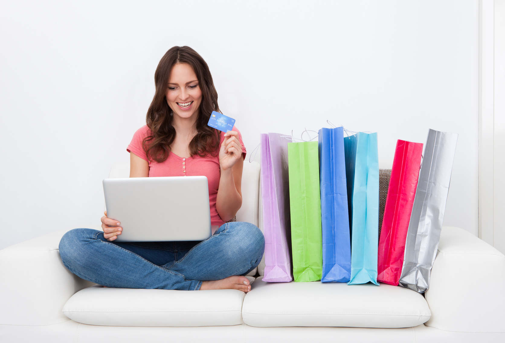 Person shopping online using promo codes to save money on purchases