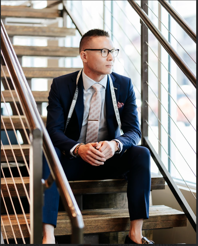 A professional smiling comfortably during an office meeting, illustrating how dressing appropriately for your environment creates a crucial sense of belonging and team connection.